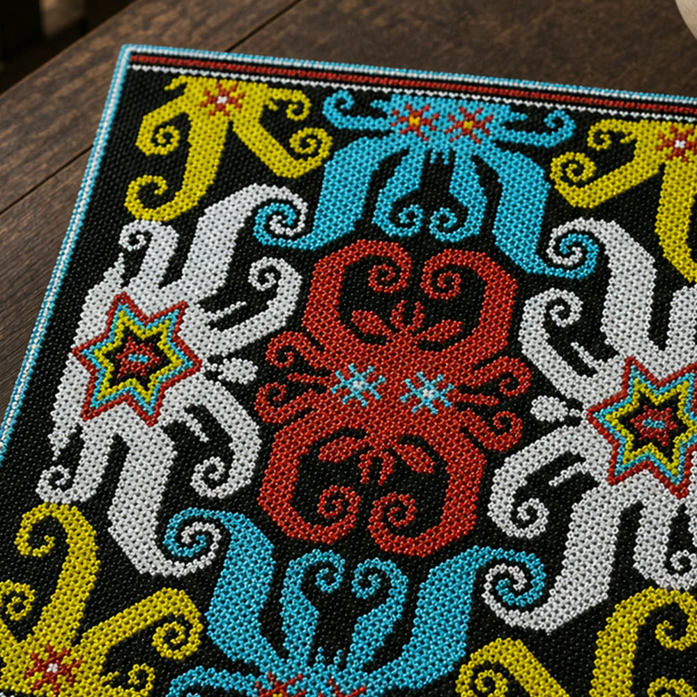 Macro detail of a mirrored red central figure framed by turquoise, white and yellow beadwork